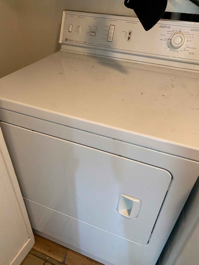 White clothes dryer in a laundry room